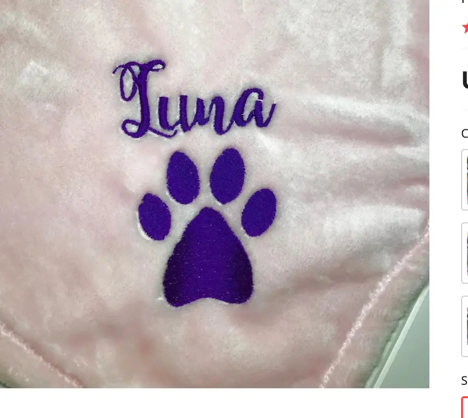 Personalised pet blanket in soft pink fabric with embroidered purple paw print and the name 'Luna,' designed for pets.